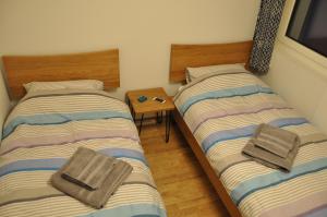 two twin beds in a room with a table at Chateaupré D 01 in Grimentz