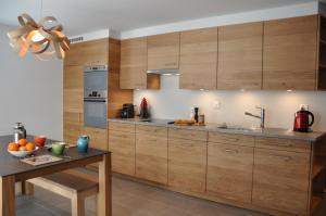 a kitchen with wooden cabinets and a table at Chateaupré D 01 in Grimentz