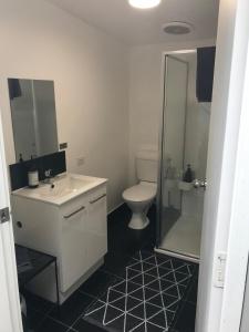 a bathroom with a toilet and a sink and a shower at The Seaside Studio Retreat in Wye River