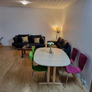 a living room with a table and chairs and a couch at Joysha's House in Ikast