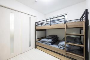 a bunk bed room with two bunk beds at Villetta Imari Ekimae III Room 104 - Vacation STAY 19028 in Imari
