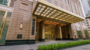 a lobby of a building with a large window at Grande Centre Point Prestige Bangkok in Bangkok