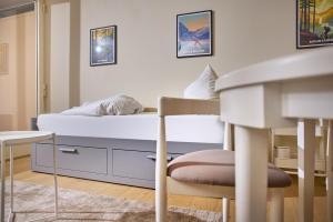 Un dormitorio con una cama, una mesa y una silla. en Studio 700hm Schruns, en Schruns