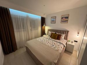 a bedroom with a large bed and a window at White Shell Sarajevo - Cozy & Stylish Apartment in Old Town in Sarajevo