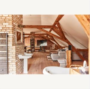 a room with a bathtub and a living room at Apartmány Pekárna 1898 in Beroun