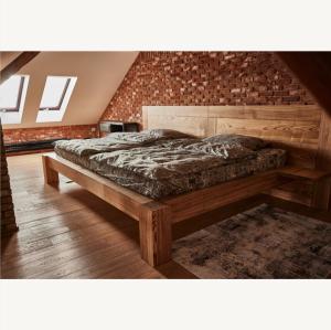 a bedroom with a large bed in a room at Apartmány Pekárna 1898 in Beroun