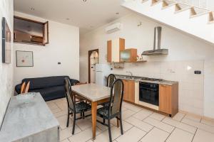 a kitchen and living room with a table and a couch at A Casa Mia in Riposto +11 photos