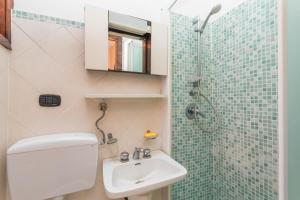 a bathroom with a toilet and a sink and a shower at A Casa Mia in Riposto