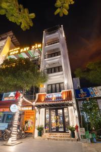 a tall white building with lights on it at C'Lau Hotel Ninh Binh in Ninh Binh +11 photos