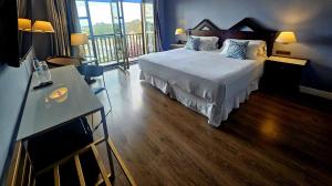 a hotel room with a bed and a balcony at RL Ciudad de Úbeda in Úbeda +64 photos