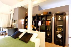 a bedroom with a bed and a book shelf at Comme une parenthèse au coeur des hortillonnages in Amiens