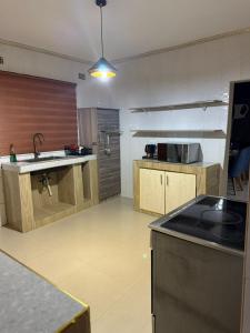 a large kitchen with a sink and a counter at Sazeesha Apartments in Ndola