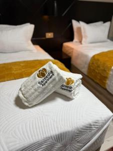 two towels are sitting on top of a bed at Sazeesha Apartments in Ndola