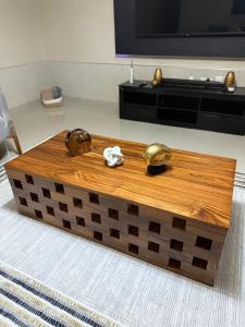 a wooden coffee table in front of a tv at Sazeesha Apartments in Ndola