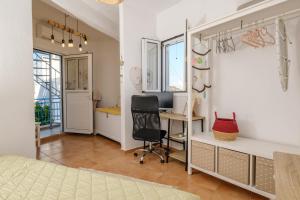 a bedroom with a desk and a chair in a room at Jasmine Summer House in Kalo Chorio