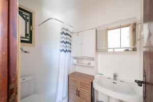 a bathroom with a sink and a toilet and a mirror at Charmante maison familiale Mandelieu-la-Napoule in Mandelieu-la-Napoule +12 photos