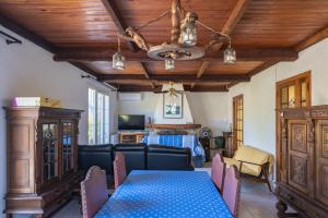 a dining room with a blue table and chairs at Charmante maison familiale Mandelieu-la-Napoule in Mandelieu-la-Napoule