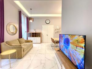 a living room with a couch and a tv at 布达城堡链子桥公寓民宿 in Budapest