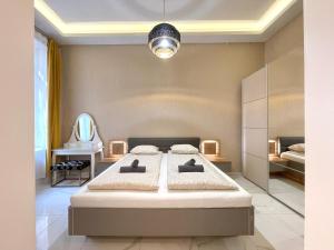 a bedroom with a large bed and a mirror at 布达城堡链子桥公寓民宿 in Budapest