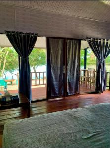 沙璜Rihlah resort的一间拥有蓝色窗帘的卧室和一张位于客房内的床