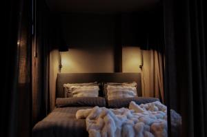 a bedroom with a bed with a blanket on it at Stylish City Suite in the Heart of Jyväskylä in Jyväskylä