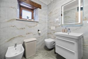 a bathroom with a sink and a toilet and a mirror at Villa Istria Mar in Pazin +21 photos