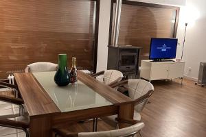 a dining room with a table with chairs and a television at Beautiful 8 Bed Apartment in Hallenberg in Hallenberg