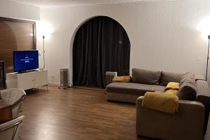 a living room with a couch and a tv at Beautiful 8 Bed Apartment in Hallenberg in Hallenberg +11 photos
