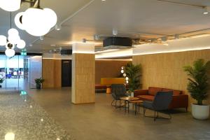 a lobby with couches and a table and chairs at Viewplace Hotel & Residence Lat Phrao 130 in Bangkok