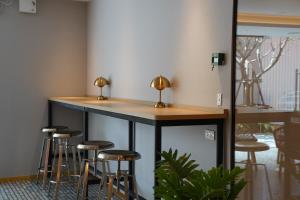 a bar with stools around it in a room at Viewplace Hotel & Residence Lat Phrao 130 in Bangkok
