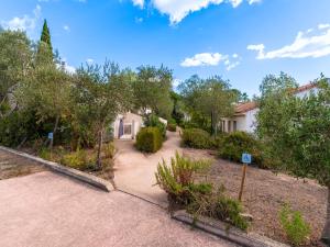 an empty driveway with trees and a house at Vacancéole - Résidence Lisa Maria in Favone