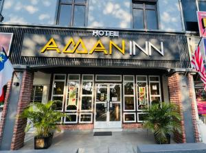 aihad hotel with a sign on the front of it at Aman Inn Hotel in Melaka