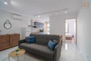 a living room with a couch and a table at Seaside Comfort in St'Pauls Bay steps from the Sea by 360 Estates in St Paul's Bay