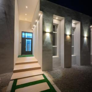 a set of stairs leading to a building at night at Alhana Oasis in Badīyah +10 photos