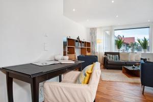 a living room with a table and a couch at Kapps Haus in Langenargen