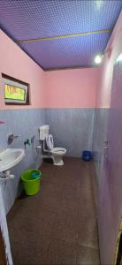 a bathroom with a toilet and a sink at Brookland Stays in Pedong