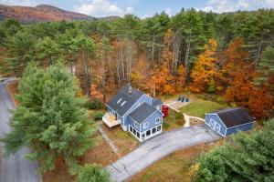 an aerial view of a house in the woods at 3BR Lake Luzerne Retreat with Game Room & Hot Tub in Lake Luzerne