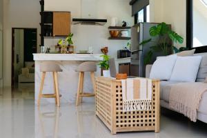 a kitchen and living room with a counter and a table at Modern 2BR Pool Villa - Near Ao Nang Beach in Ao Nang 