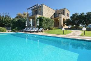 a house with a swimming pool in front of a house at Stone Built Private villa Emerald with pool, 30m to Beach & BBQ! in Ropanianá +41 photos