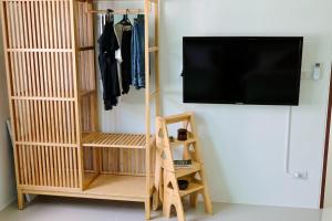 a tv hanging on a wall next to a closet at Modern 2BR Pool Villa - Near Ao Nang Beach in Ao Nang 