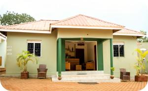 a small house with a green at Go Culture Africa in Entebbe