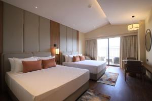 Ένα ή περισσότερα κρεβάτια σε δωμάτιο στο Lemon Tree Hotel, Mall of Dehradun, Dehradun