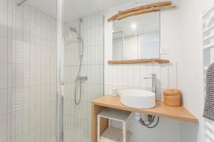 a bathroom with a sink and a shower at Villa L’hirondelle in La Michelière +21 photos