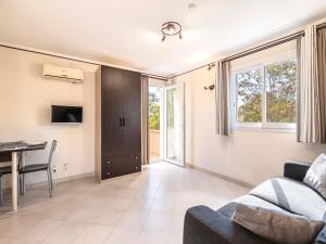a living room with a couch and a table at Vacancéole - Résidence Lisa Maria in Favone