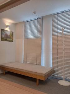 a bedroom with a bed in front of windows at 해운대 엘본 # Haeundae station 3min# sea 3min# high floor view# luggage storage# flexible checkin& out# family in Busan