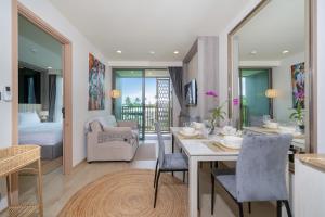 a kitchen and living room with a table and chairs at Ozone Condominium BangTao Laguna Area in Phuket +27 photos
