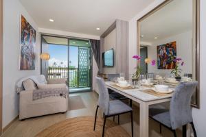 a dining room with a table and chairs at Ozone Condominium BangTao Laguna Area in Phuket
