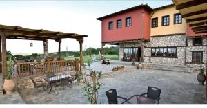 a patio of a house with a table and chairs at Estate Kalaitzis in Vergina