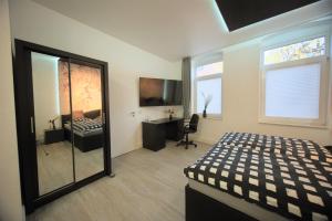 a bedroom with a bed and a desk and a mirror at Appartment Junior Suite in Springe
