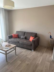 a living room with a couch and a coffee table at Wattrelos Appart'S in Wattrelos